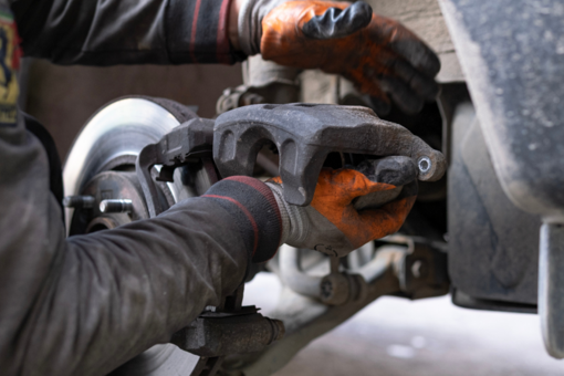 Technician working on a vehicles brake system
